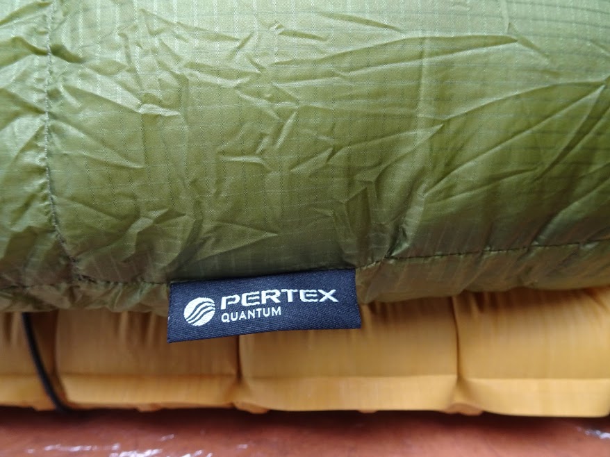 The Pertex Quantum shell is thin and light. It feels comfortable next to skin, however it leaked one or two downs.